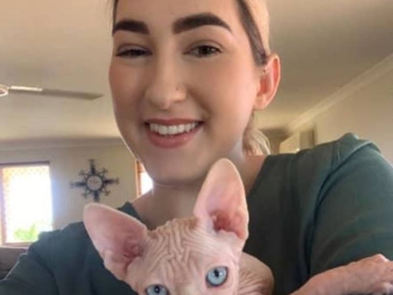 Happy Sphynx kitten owner with her Sphynx kitten